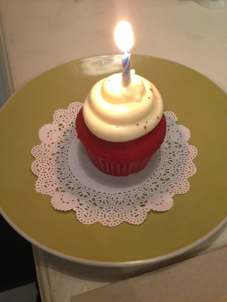 Red velvet mini cake with cream cheese frosting and birthday candle
