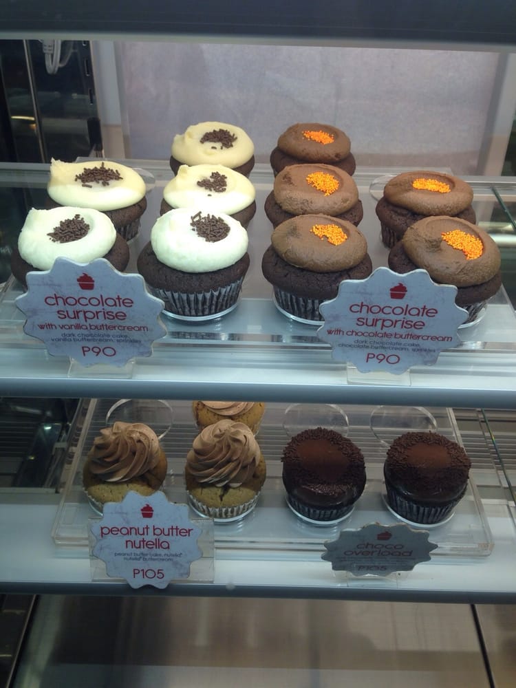 Premium cupcakes in display - chocolate surprise and peanut butter nutella