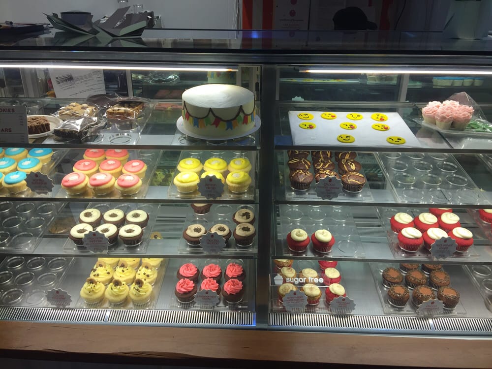 Custom celebration cakes and cupcakes in display case